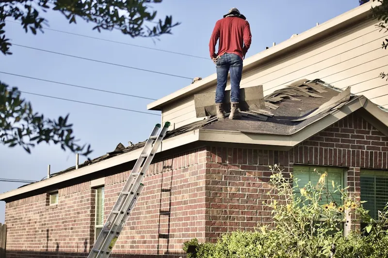 Professional roofer working on a residential roof in Wiggins